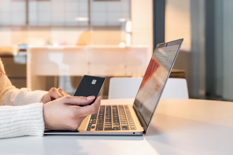 A woman at a laptop paying for something online