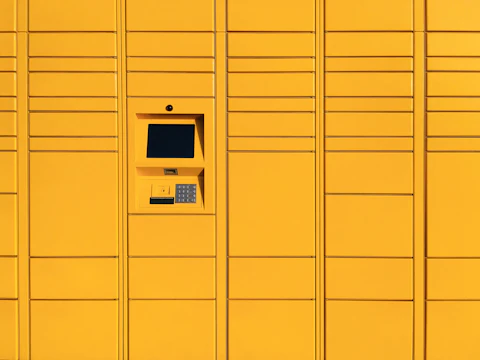 A wall of yellow parcel lockers