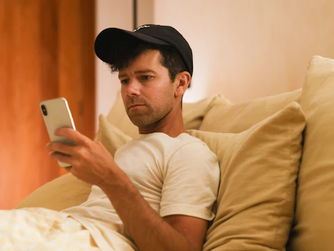A young man concentrating on his phone